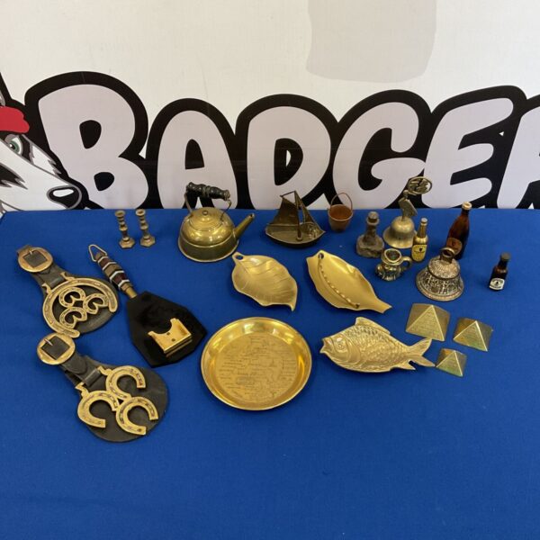Vintage brassware collection featuring a decorative fish platter.