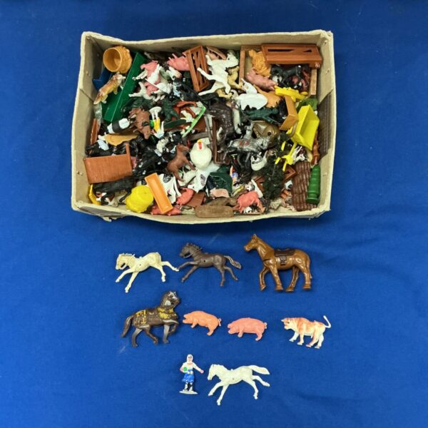 Vintage Britains model animals in a box, collectible farm toys.