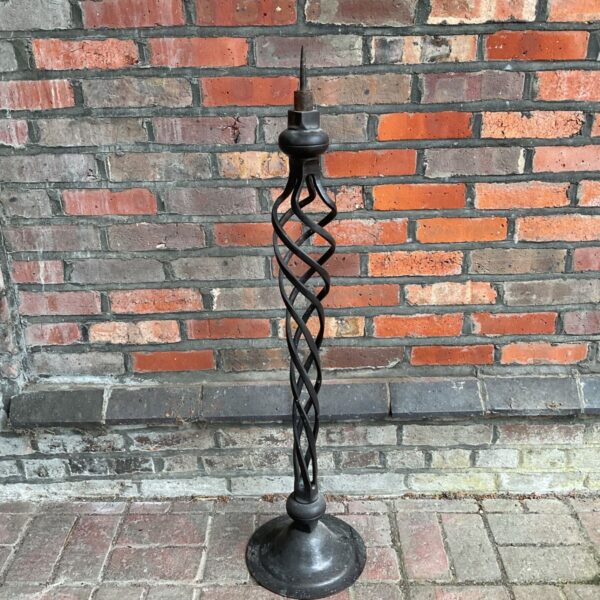 Large antique bronze candlestick with a twisted stem.