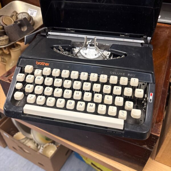 Vintage Brother Deluxe 220 portable typewriter in its case.