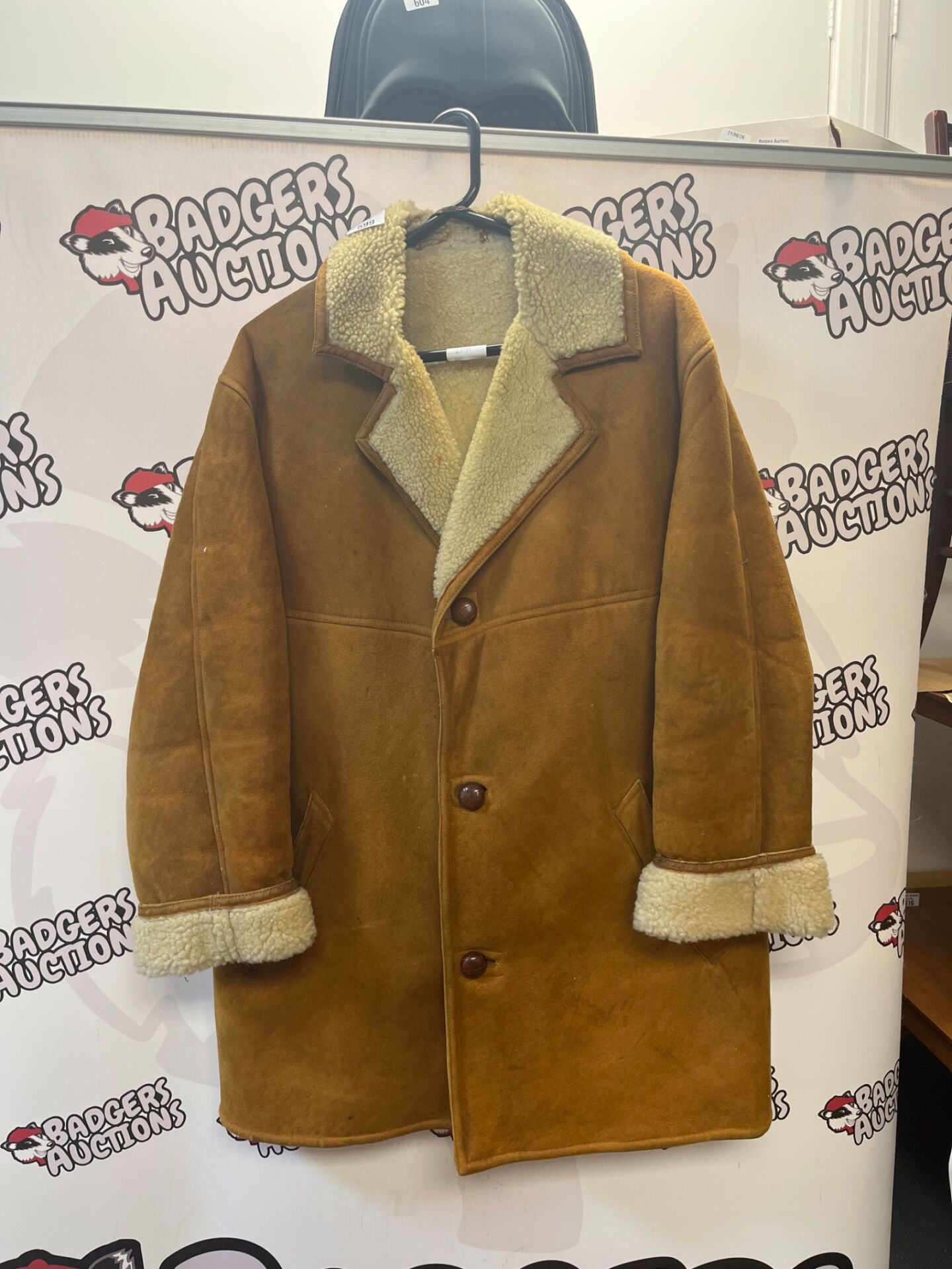 599 brown suede jacket features a classic shearling lining and a notched collar