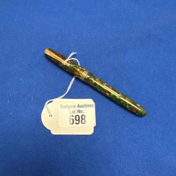 Vintage Burnham fountain pen with auction tag, green and gold marbled.