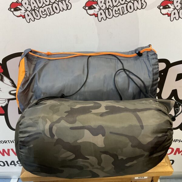 Camouflage sleeping bags rolled up and ready for outdoor adventures.