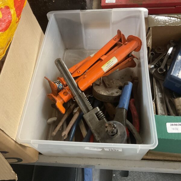Box of automotive tools including a car jack and wrench.
