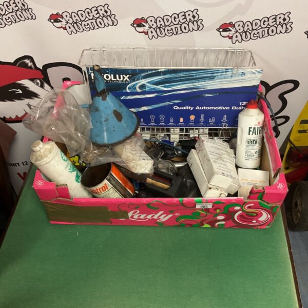 Box of car repair tools and replacement bulbs for automotive maintenance.