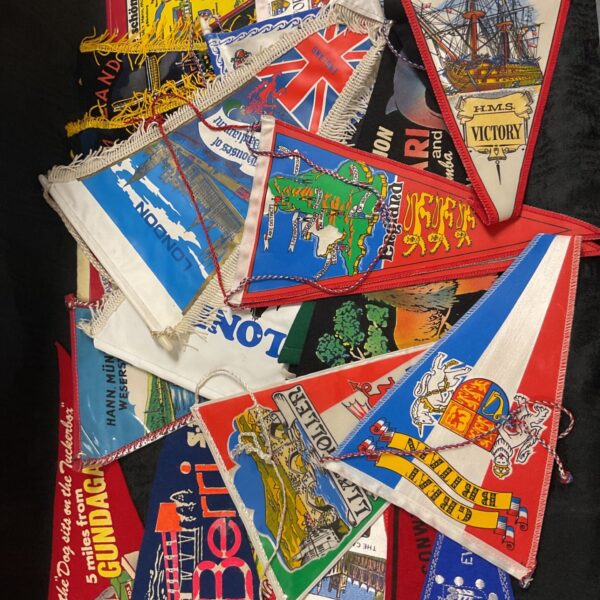 Vintage caravan holiday pennants, a colourful collection of travel souvenirs.