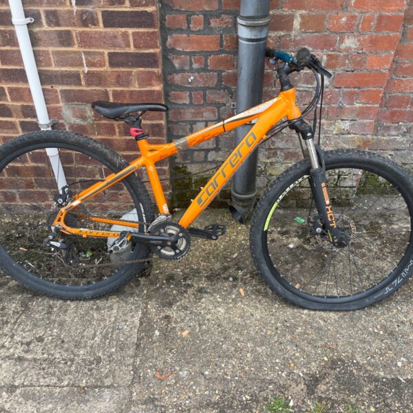 Orange Carrera Vengeance mountain bike with front suspension.