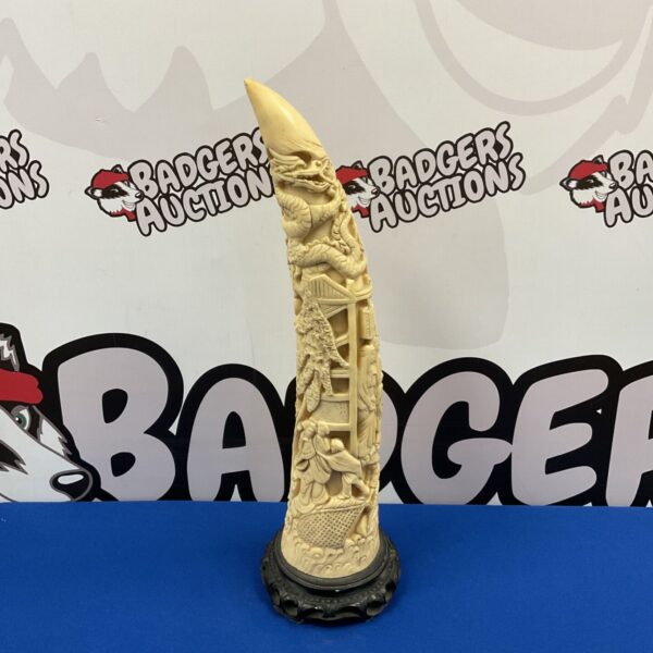 Intricately carved faux ivory horn featuring a dragon design.