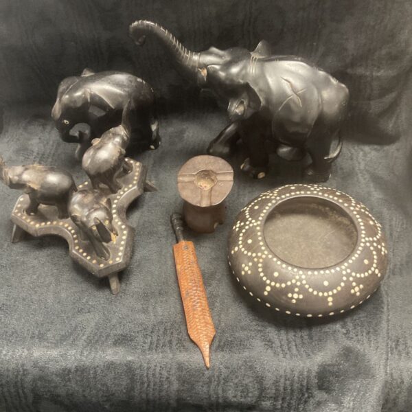 Group of vintage carved wood elephants and Asian artefacts.