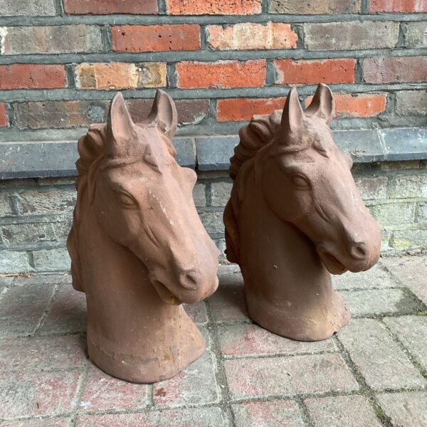Antique cast iron horse head busts for garden decoration.