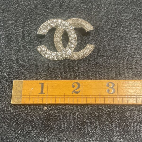 Vintage Chanel-style crystal brooch, sparkling double C design.