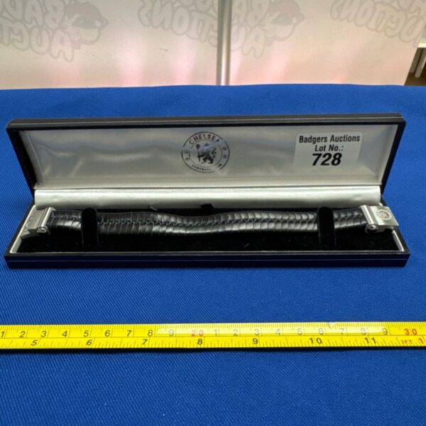 Chelsea FC leather bracelet in auction display case.