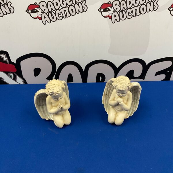 Vintage porcelain cherub figurines in a praying pose.