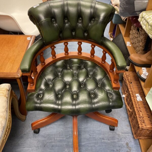 Green leather Chesterfield captains desk chair with mahogany base.