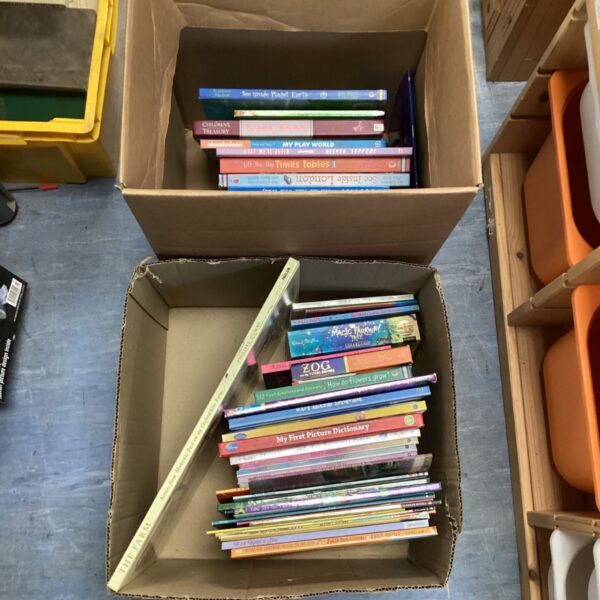 Stacked boxes of colourful childrens books for young readers.