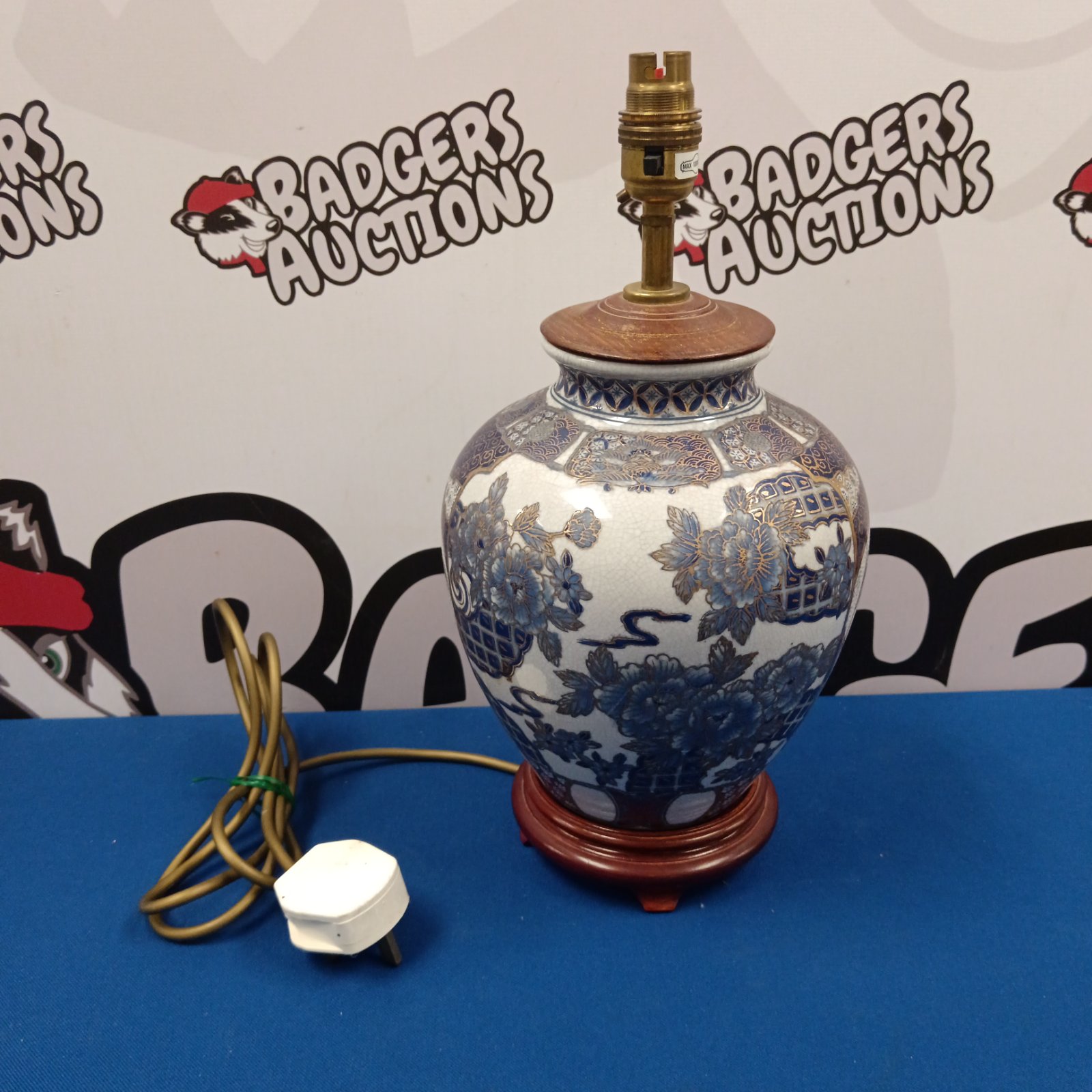 Chinese blue and white porcelain table lamp with wooden base.