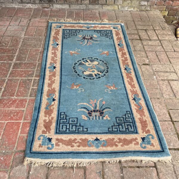 Blue Chinese hand-knotted rug with bird medallion and peach border.