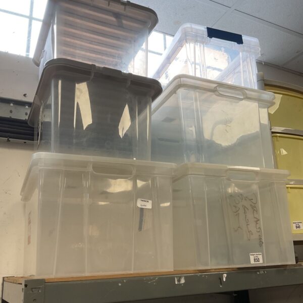 Stack of six large clear plastic storage boxes for organisation.