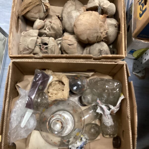 Vintage coconut carvings and glassware collection for display.