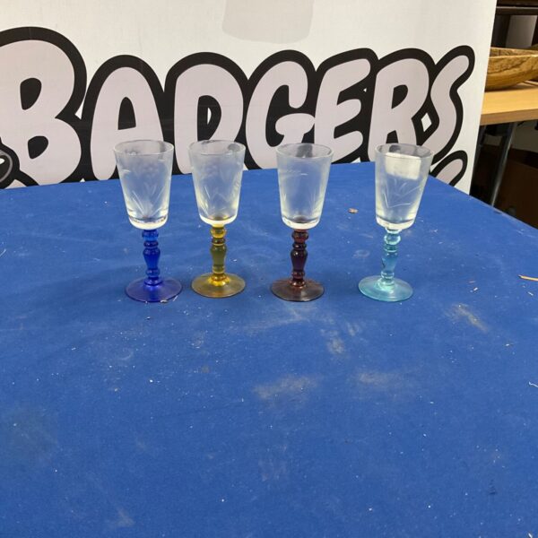 Set of four colourful cut glass sherry glasses.