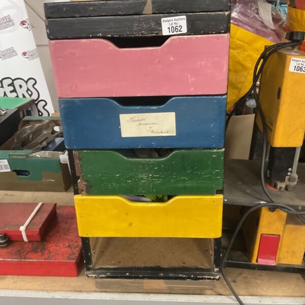 Set of colourful wooden storage drawers for workshop or craft use.