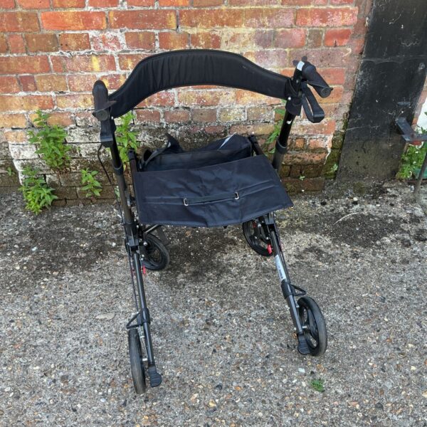 Used Comet rollator wheelchair with a black seat and folding frame.