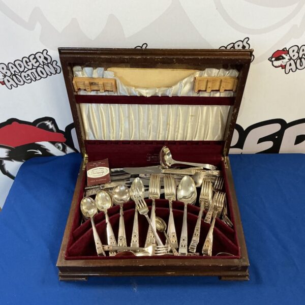 Open presentation case displaying vintage Community silver plate cutlery set.