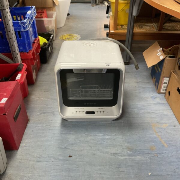 White Cookology CMDW2 tabletop dishwasher in a workshop setting.