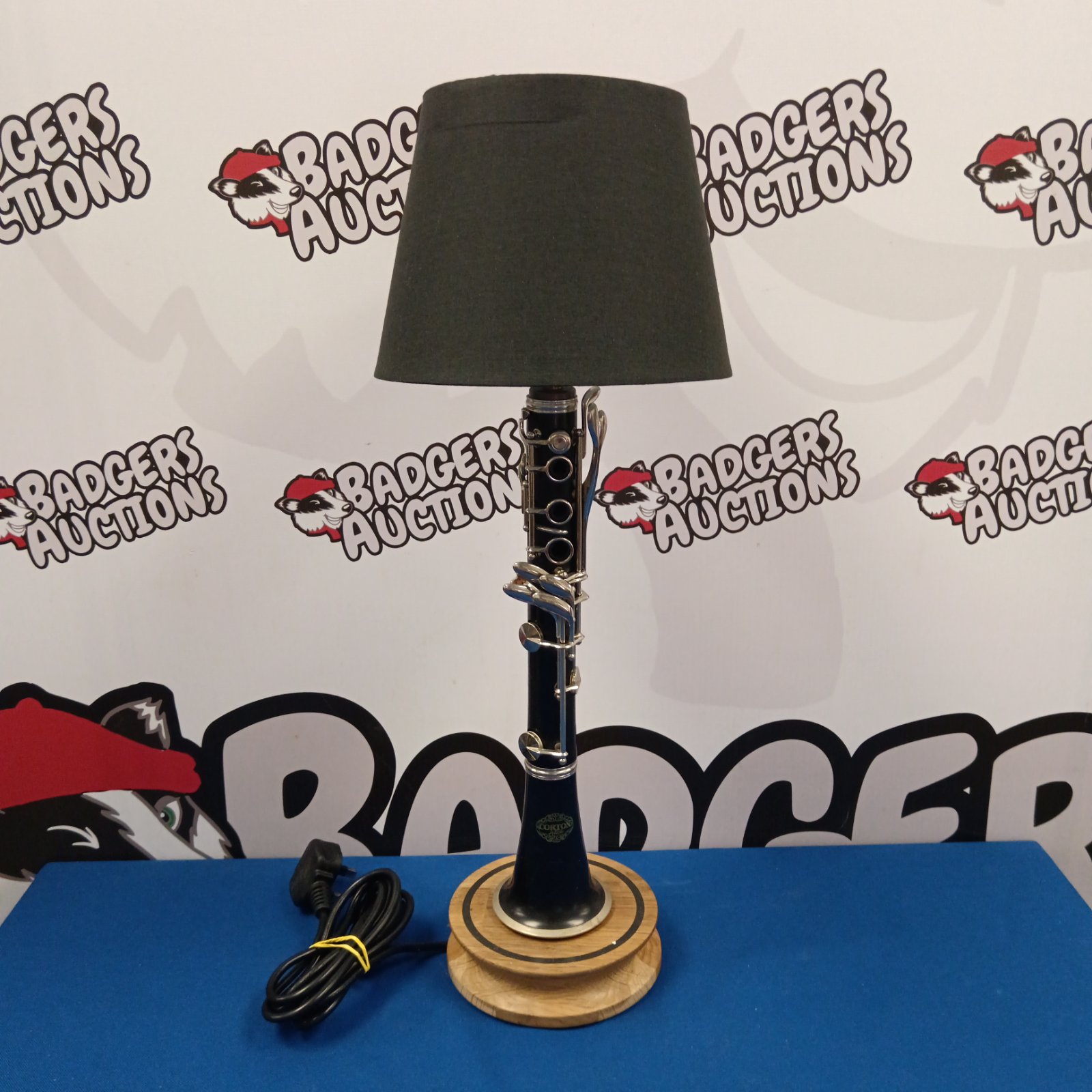 Vintage Corton clarinet lamp with black lampshade, side view.