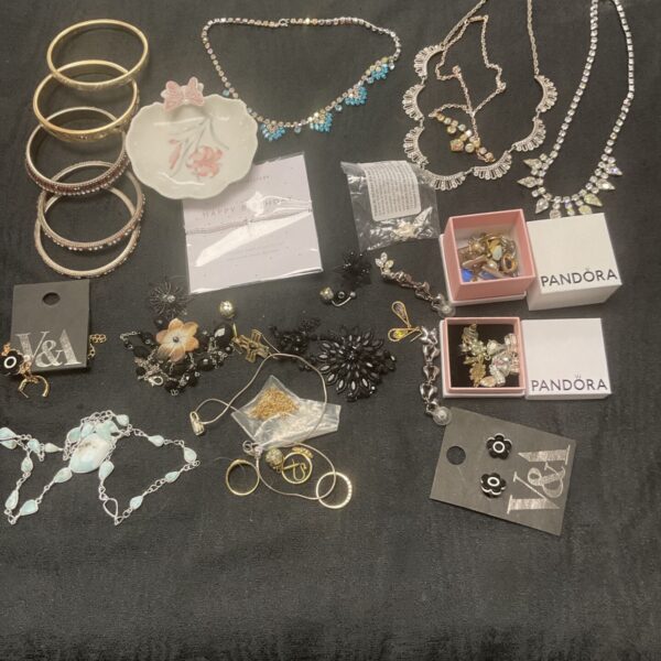 Tray of assorted vintage costume jewellery including necklaces and brooches.