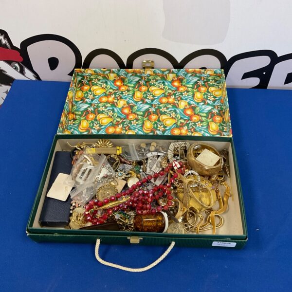Box of vintage costume jewellery with necklaces and brooches.