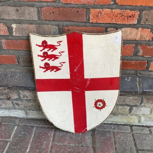 Wooden Crusader shield with a red cross and lions.