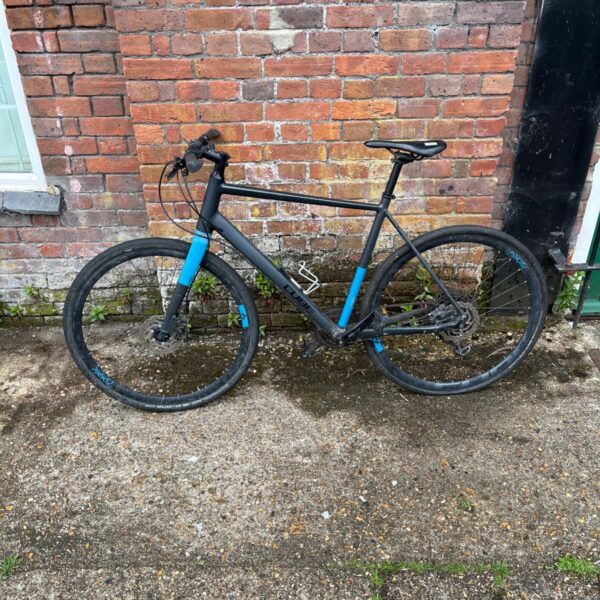 Side view of a blue Cube SL Road Pro hybrid bike.