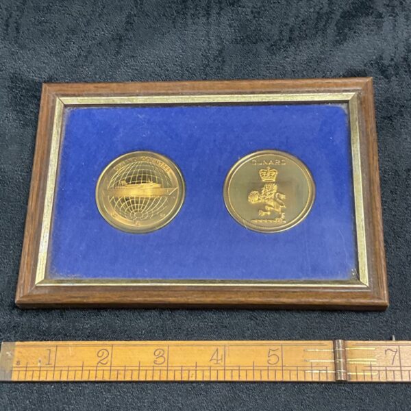 Framed Cunard Countess coin set with ship and crest.