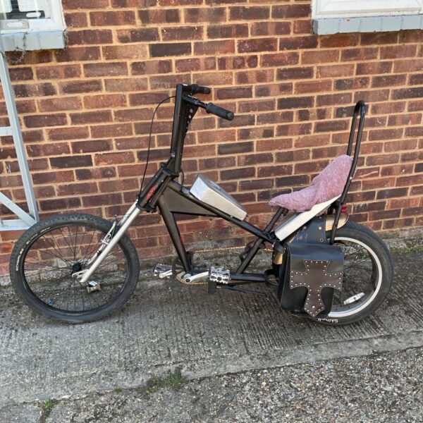 Custom electric chopper bicycle with unique design and high handlebars.