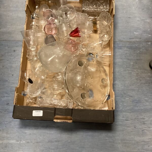 Assorted vintage cut glass pieces in a box.