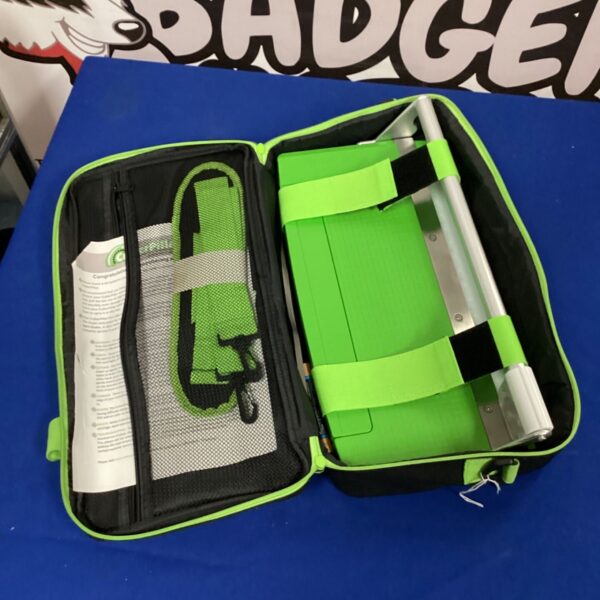 Green Cutterpillar cutting machine case with internal straps.