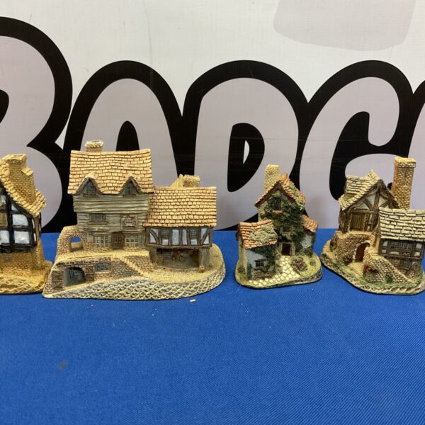 Group of four David Winter Lilliput Lane cottages, collectible miniature village buildings.