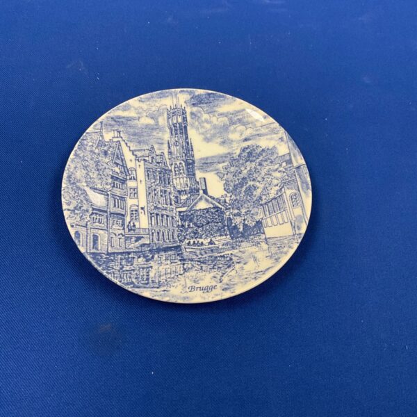 Hand-painted Delfts Blauw plate featuring a Bruges canal scene.