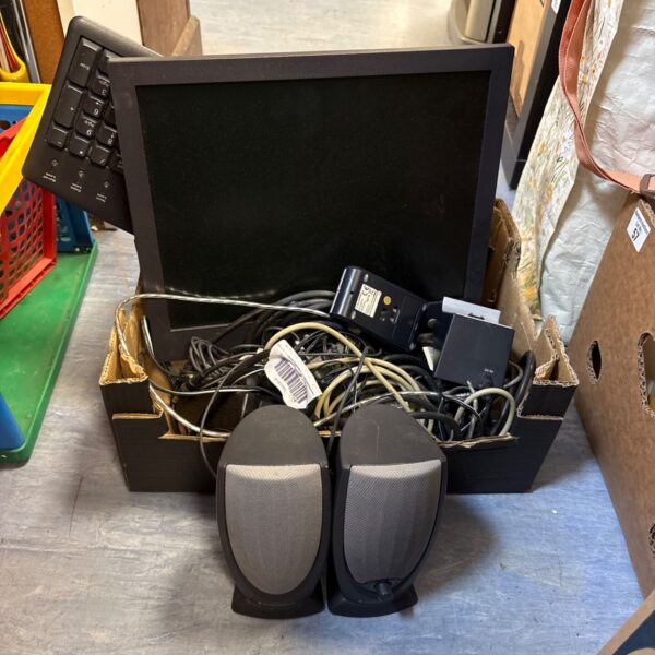 Dell computer monitor with keyboard and mouse in a cardboard box.