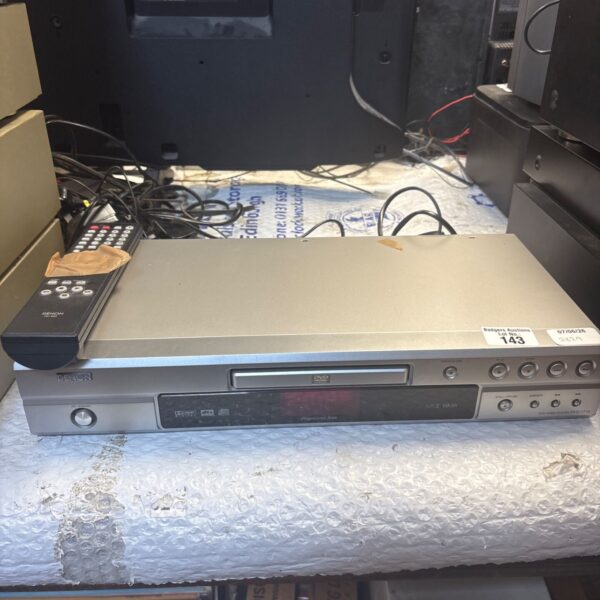 Black Denon DVD-1710 DVD player with remote control.