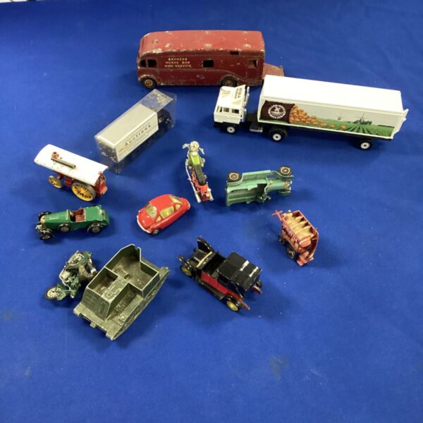 Vintage Dinky Toys diecast lot, including a red van and other vehicles.