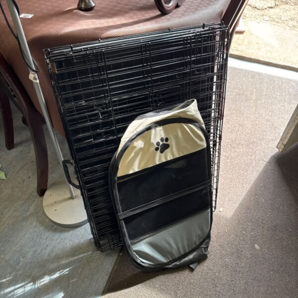 Medium dog crate with a small pet carrier beside it.