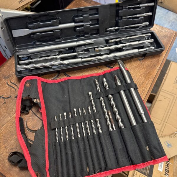 Drill bit sets in plastic cases, workshop tools.
