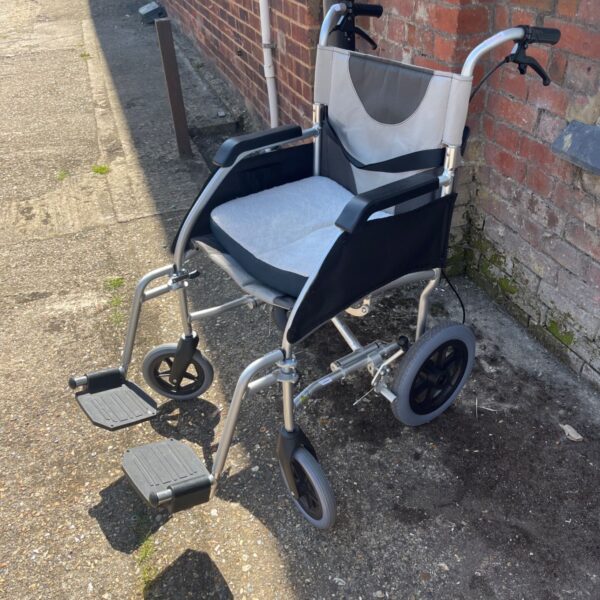 Silver Drive DeVilbiss Enigma transit wheelchair with gray seat.