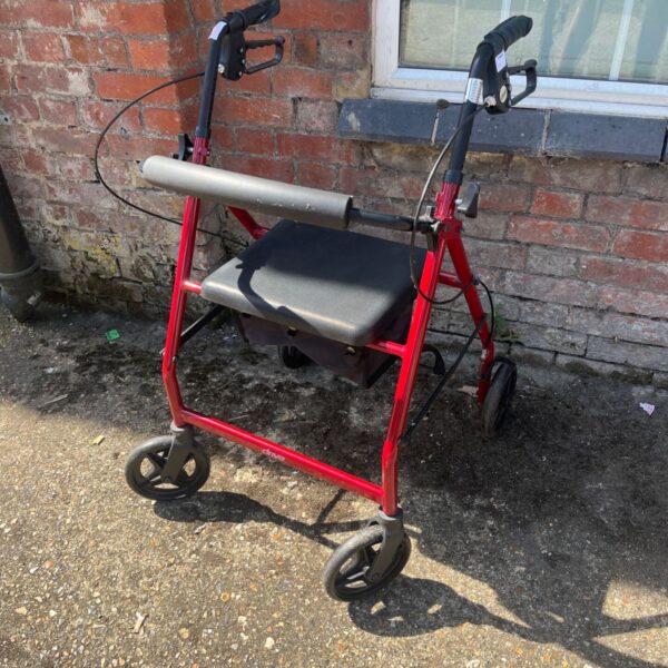 Red Drive Medical rollator walker with padded seat and hand brakes.