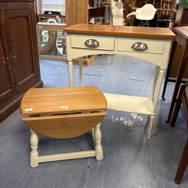 Cream coloured drop leaf console table with a single drawer.