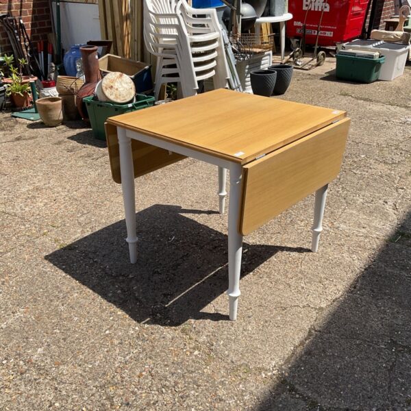 Vintage drop leaf oak table in a garden setting.