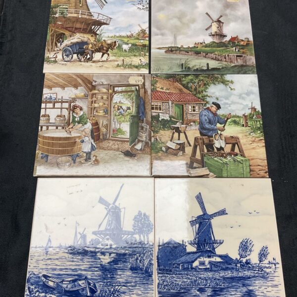 Group of six hand-painted Dutch ceramic tiles with windmill scenes.