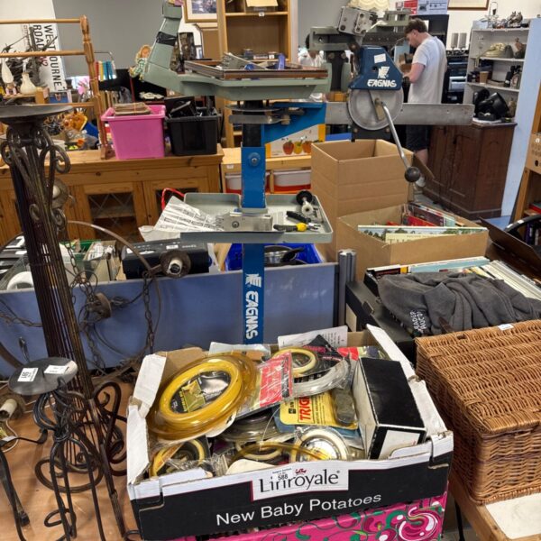 Eagnas stringing machine with accessories in a cluttered workshop.
